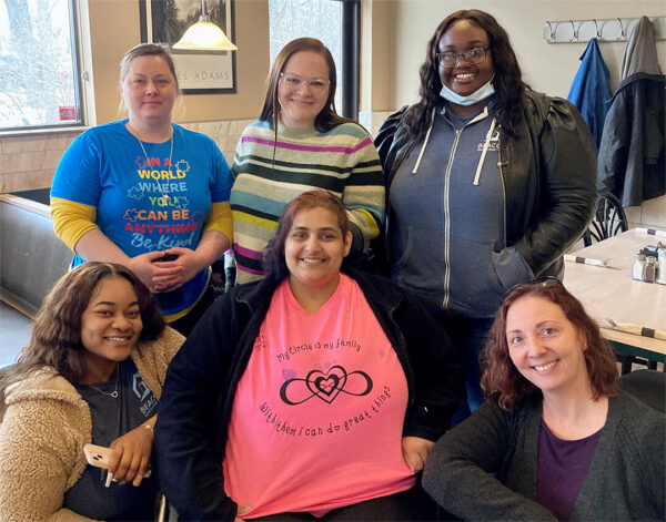 Resident Smiling with Staff at Goodrich Home.