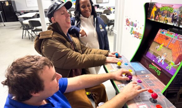 Staff and Individuals VA 1.12.26-029 Two guys playing an arcade game