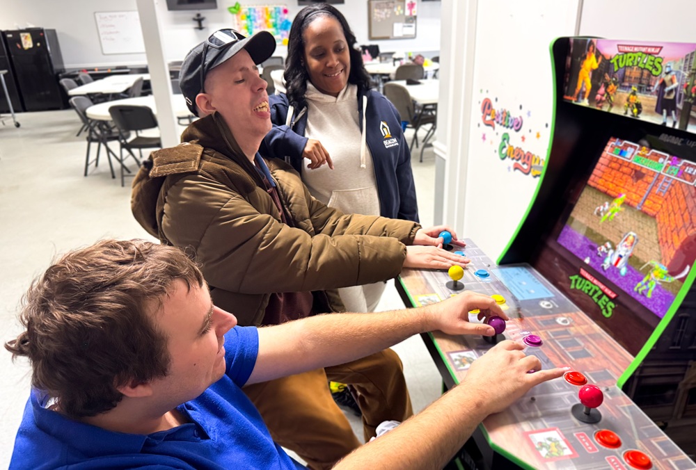 Staff and Individuals VA 1.12.26-029 Two guys playing an arcade game