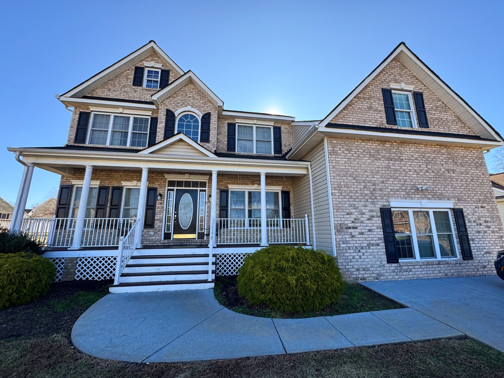 home-exterior-referral-page Exterior of a large, tan, brick home.