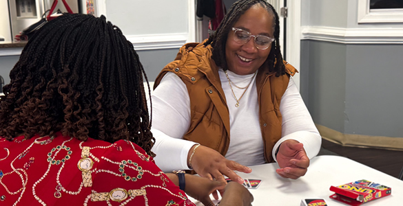 Two women playing UNO.
