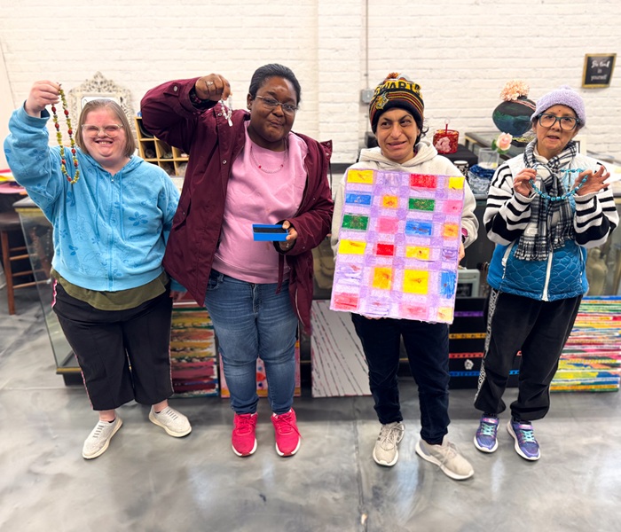 individuals-day-program Group of individuals showing off crafts they made.